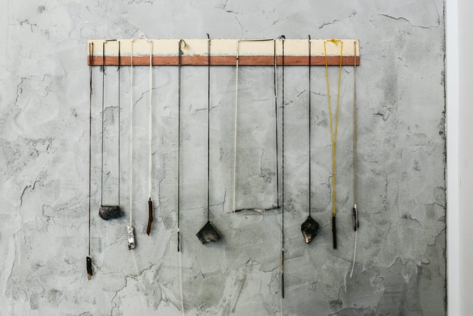 Necklaces hanging from a shelf.