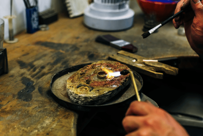 A jeweller adding the final touches to a handmade ring with a blowtorch
