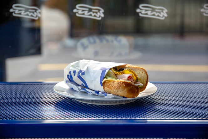 Close up of a sandwhich on a blue counter.