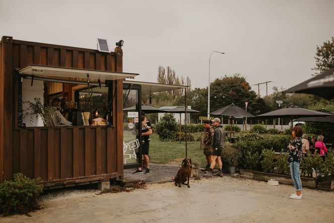 People milling about the Red Bridge Coffee caravan.