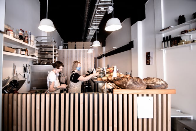 People working behind the counter at Harvest Deli.
