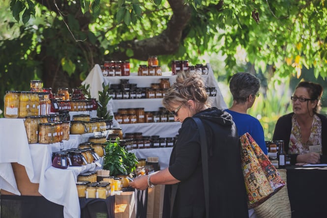 A woman browsing a market stand.