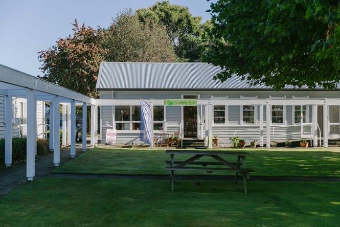 The little white exterior of Simply Eco on a sunny day.