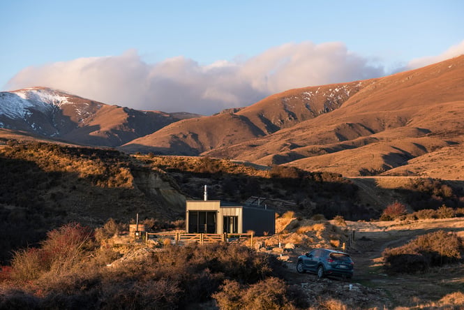 A view of a hut at dusk.