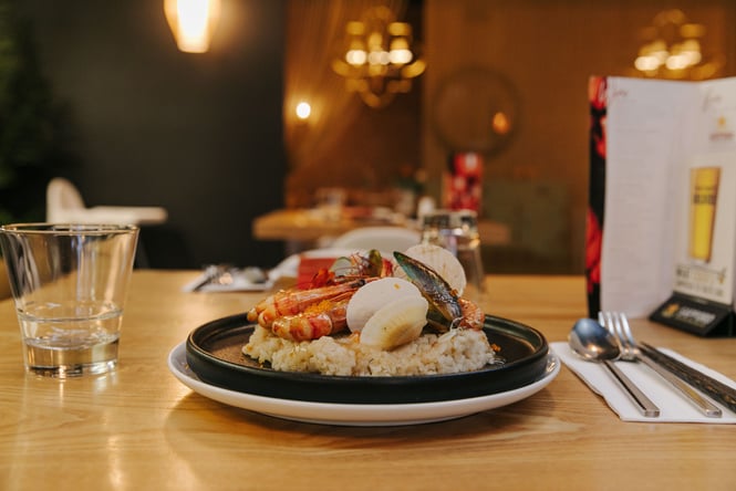 Shell fish on a plate of rice.