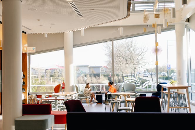 Two people sitting inside the Rolleston library cafe.