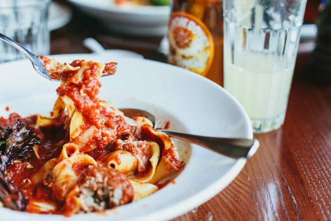 A close up of a plate of tomato pasta.