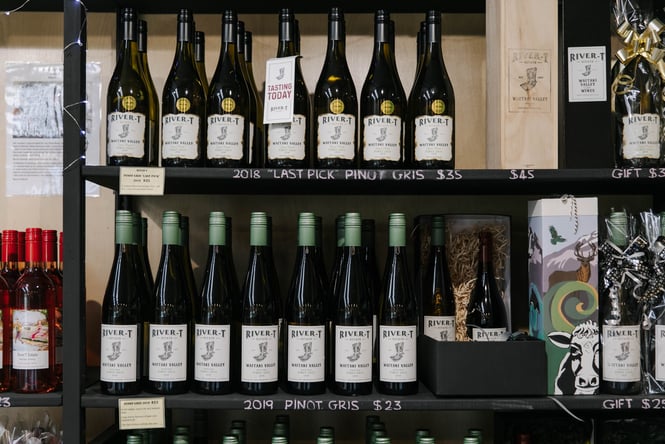 Close up of wine bottles on display.