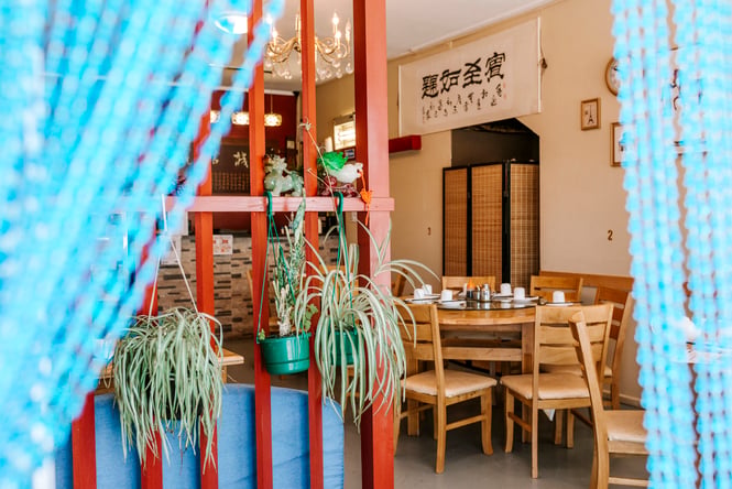 The view of the Tianze restaurant through blue curtains.