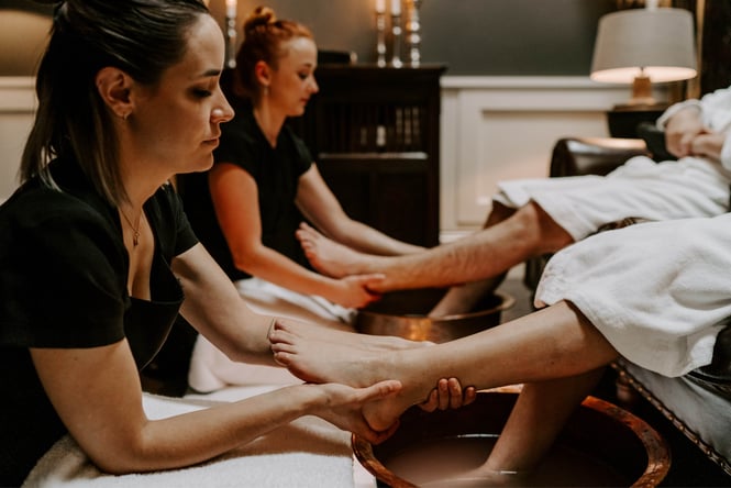 Two staff members doing pedicures.