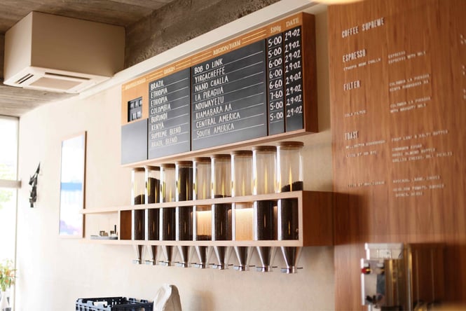 Different types of coffee beans on display on a wall inside Customs.