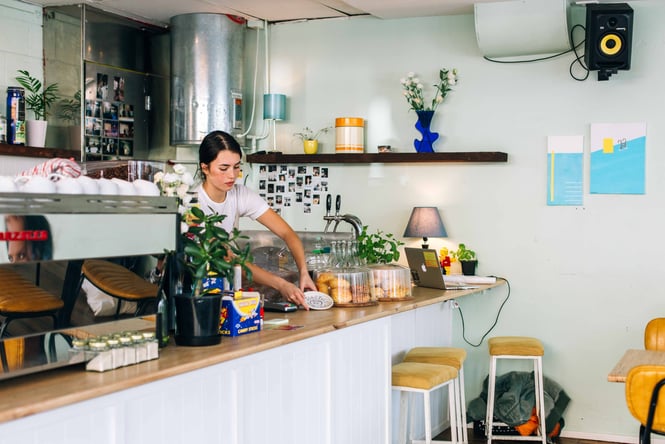 A woman working behind the counter at Swimsuit.