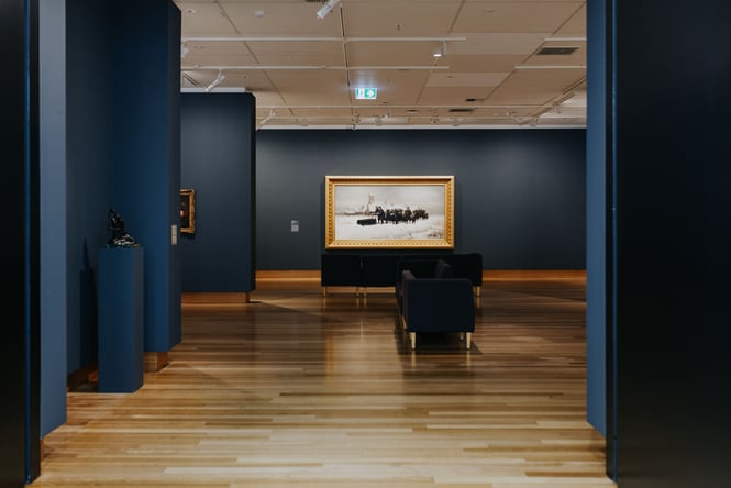 Art on blue walls at the gallery.