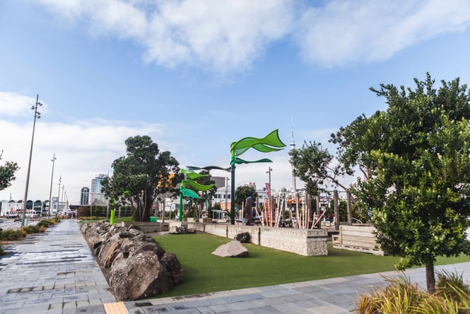 A seating area next to faux green grass at Silo Park.