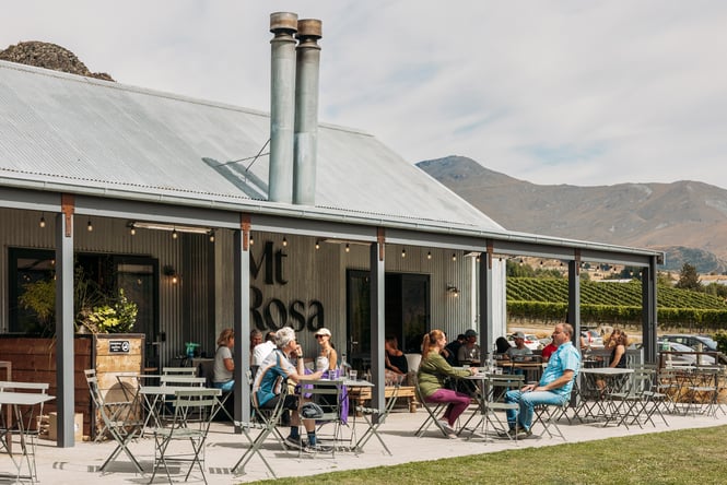 People dining outside Mt Rosa on a sunny day.