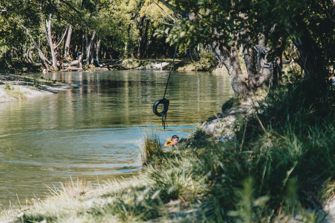 A boy swimming in a lake.