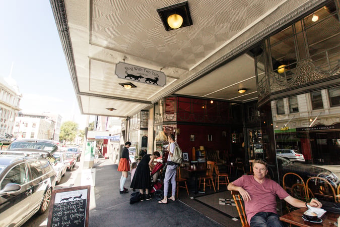 People milling about on Moray Place in Dunedin.