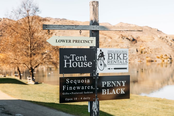 A lake view in Cromwell with signs in the forefront.