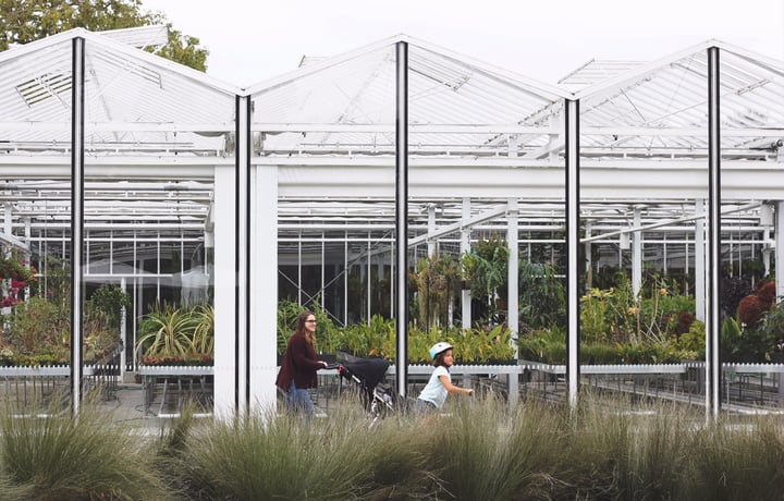 Woman with two children walking through the botanical gardens in Christchurch.