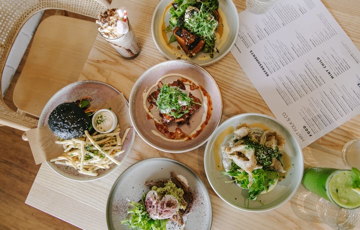 A flatlay of plates of food on a table at Mint Folk in Twizel.