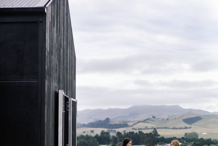Two woman dining outside at Black Estate.
