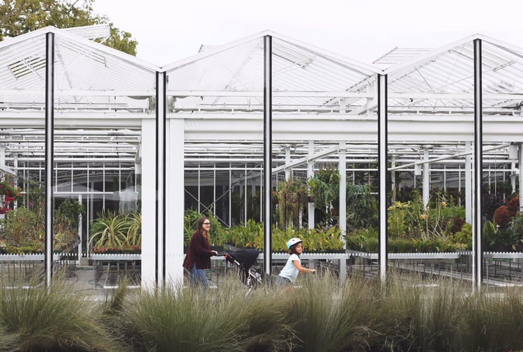 Woman with two children walking through the botanical gardens in Christchurch.