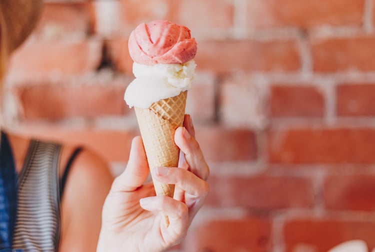 A hand holding an ice cream.