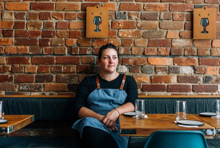 Leslie Hottiaux sitting in her restaurant.