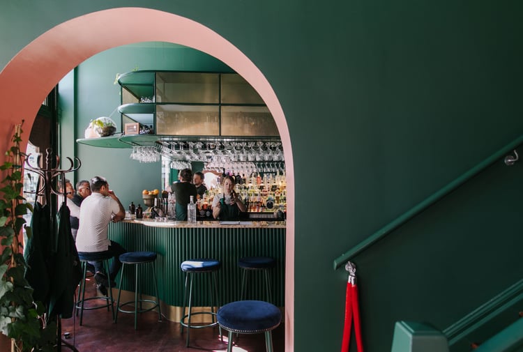 Interior view of gin gin feature green and pink contrast archway.