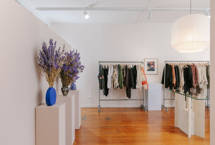 Clothing on display on racks inside Company Store Dunedin.
