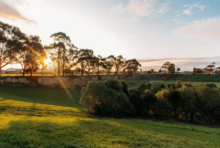 The sun setting over Edward Pit Park on a clear day.