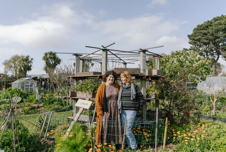 Catherine O’Neill and Lin Klenner smiling in their New Brighton Community Gardens.