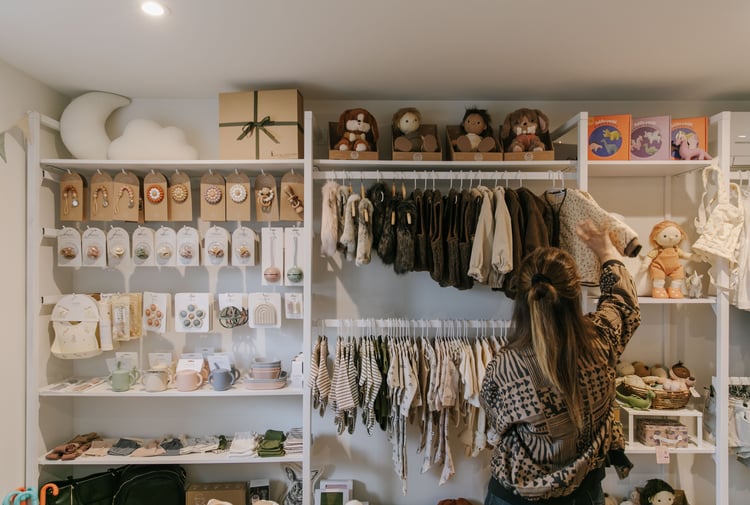 Customer browsing a selection of kidswear at Lily & Langford in Christchurch