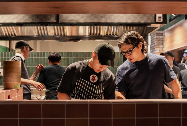 Two men working in a hot looking kitchen.