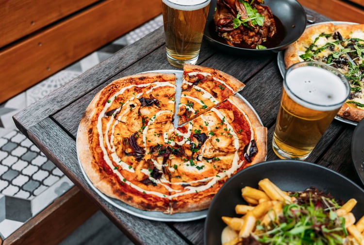 Pizza and other food on the table.