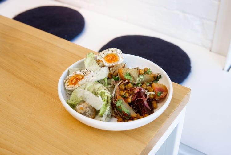 Bowl of fresh salad with a boiled egg on the table at Estelle Cafe in Christchurch