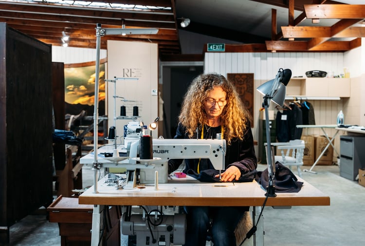 A woman working at a sewing machine.
