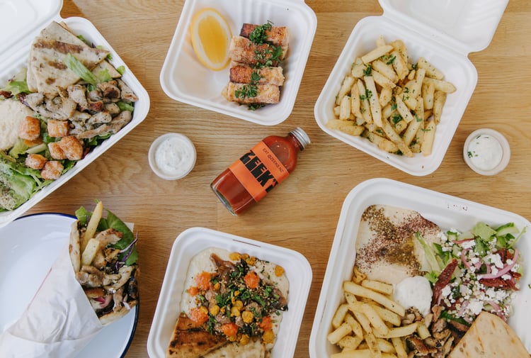 A flatlay of salads and hot chips on a table at Zeek's.