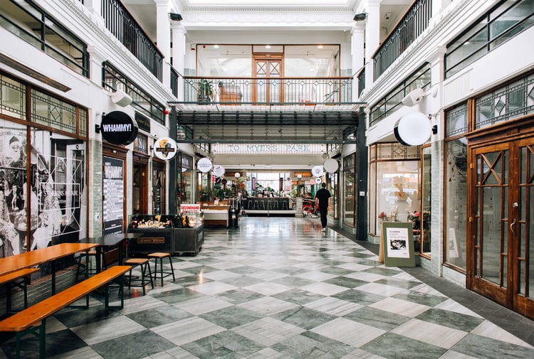 A covered arcade filled with shops.