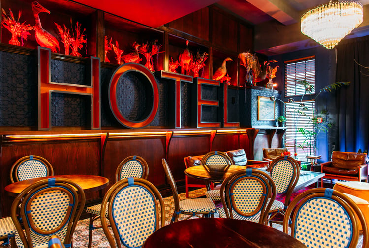A massive red 'HOTEL' sign on a wall.