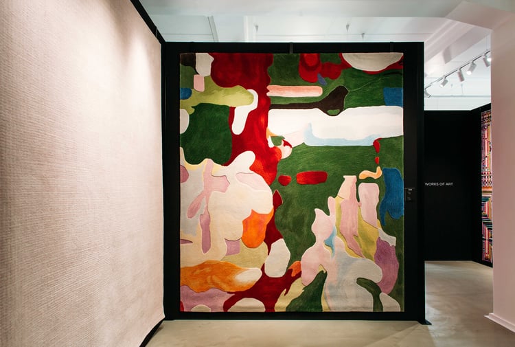 A colourful rug on a wall at Hanrad Bespoke Rugs Hamilton.