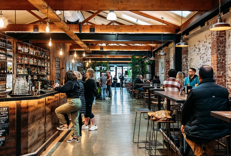 Customers at the bar at Brew Union.