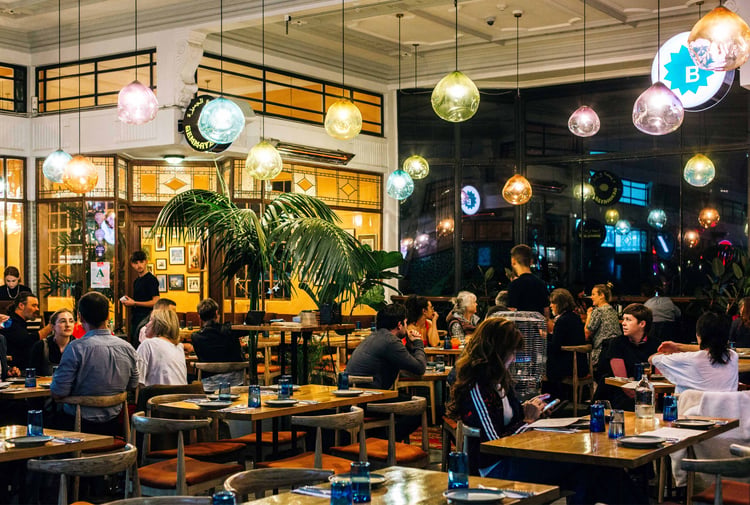 Customers dining under colourful bulbs at Gemmayze Street in Auckland.