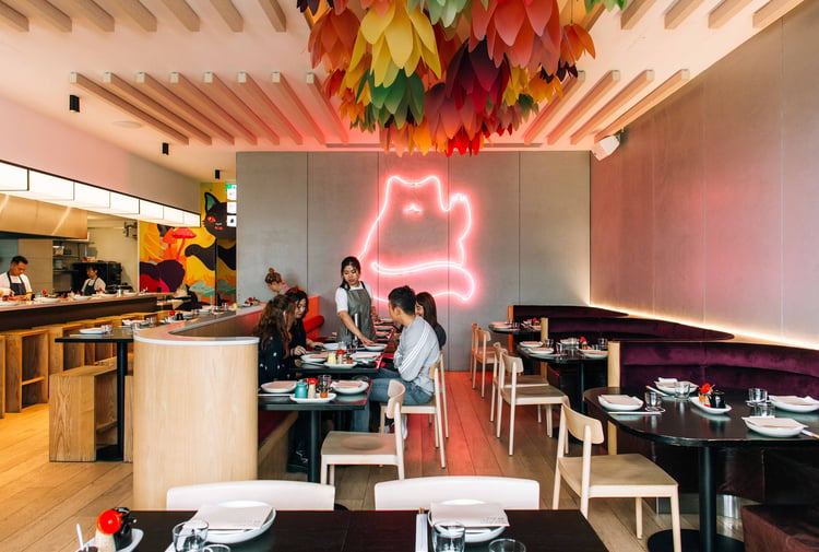 A group of customers sitting at a table inside Hello Beasty in Auckland.