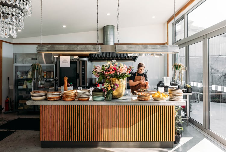 A woman working behind the cafe counter at Packing Shed.