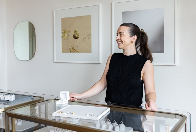 Shop assistant behind a jewellery counter.