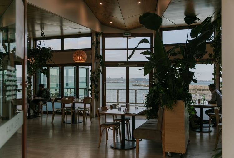 The inside of a restaurant next to the ocean.