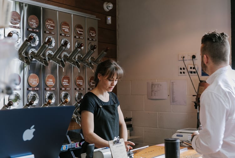 A woman working behind the counter at C4.