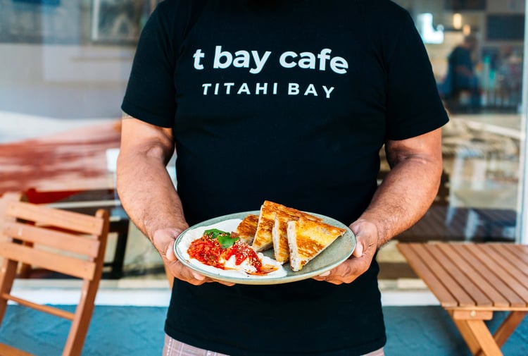 Man holds a food dish in front of himself.