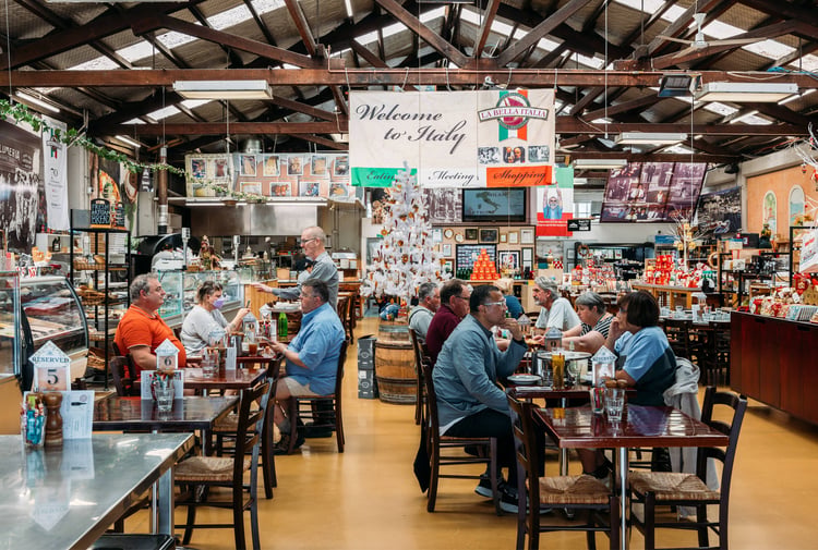 People dining at tables inside an Italian restaurant.